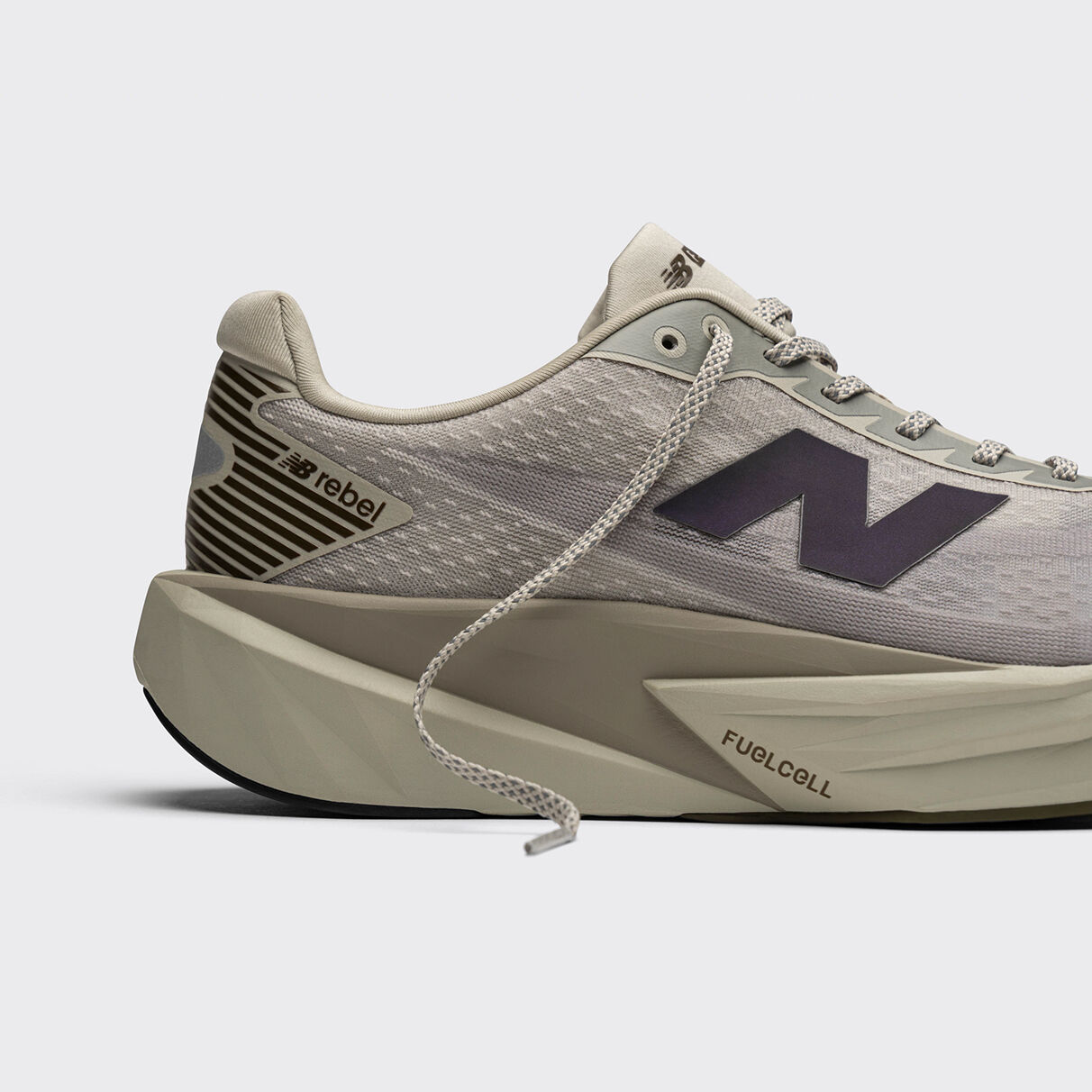 Pile of New Balance sneakers on beige background